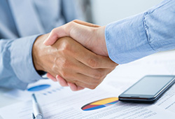 Businessmen shaking hands after CFO Outsource work